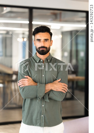 Portrait of serious Middle Eastern businessman standing in office Portrait of serious Middle Eastern businessman standing in office 143292713