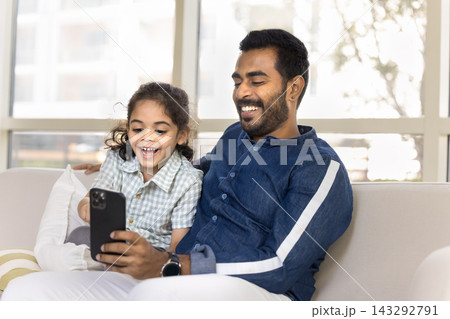 Little 6s son and dad using mobile phone at home Little 6s son and dad using mobile phone at home 143292791