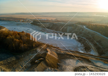Aerial view of open pit mine of sandstone materials for construction industry with excavators and dump trucks. Heavy equipment in mining and production of useful minerals concept Aerial view of open pit mine of sandstone materials for construction industry with excavators and dump trucks. Heavy equipment in mining and production of useful minerals concept 143293020