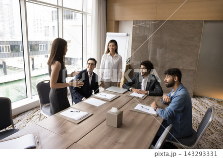 Friendly multiracial teammates Asian woman coach listen to female coworker 143293331