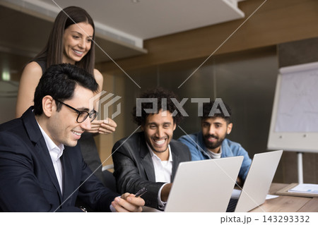 Diverse multicultural team and female boss discuss operations on laptops 143293332