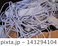 Tangled pile of white extension cables 143294104