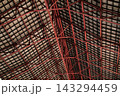 Red metal frame of a large roof 143294459