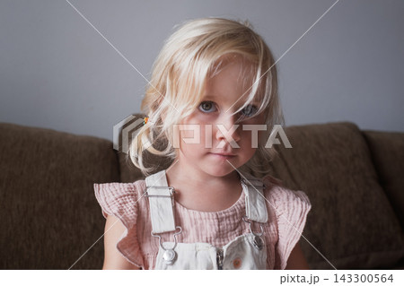 Little Blonde Girl Looking at the Camera Indoors Little Blonde Girl Looking at the Camera Indoors 143300564