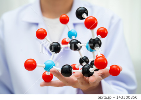 Scientist holding molecular model for chemical technology. Scientist holding molecular model for chemical technology. 143300850