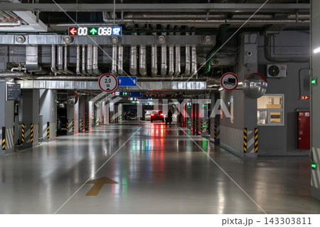 Underground Parking Garage Interior With Cars, LED Signs and Reflective Polished Floor Underground Parking Garage Interior With Cars, LED Signs and Reflective Polished Floor 143303811