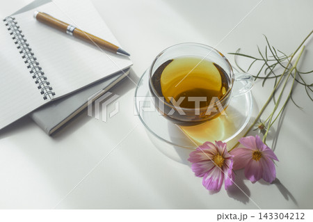 紅茶とノート、ペンとピンクのコスモスを添えた秋のテーブルフォト 紅茶とノート、ペンとピンクのコスモスを添えた秋のテーブルフォト 143304212