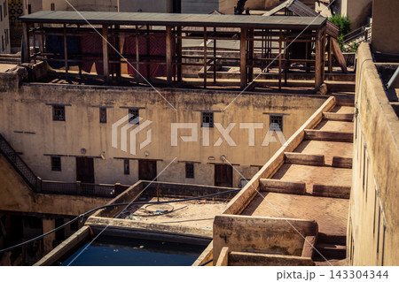 Elevated view of dye vats at the historic Chouara Tannery in Fes 143304344