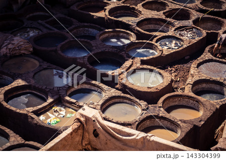 Elevated view of dye vats at the historic Chouara Tannery in Fes 143304399