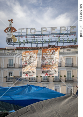 Temporary encampment in Puerta del Sol Madrid with tents tarps signs and temporary structures set up in the central square Temporary encampment in Puerta del Sol Madrid with tents tarps signs and temporary structures set up in the central square 143305169