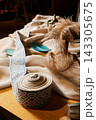 Woven blue geometric belt pattern on beige linen fabric with rolled edge detail Woven blue geometric belt pattern on beige linen fabric with rolled edge detail 143305675