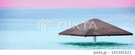 A parasol on the water at the Leonardo Club's private beach. The beautiful Dead Sea 143305821