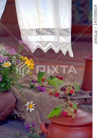Pottery, berries, and wildflowers on the porch of an old country house. Country style 143306614