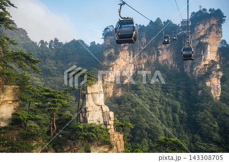Tourists ride cable cars through Zhangjiajie National Forest Park to see the scenic sandstone peaks 143308705