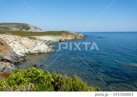 Scenic rocky cliffs lining the coast of North Corsica above the clear Mediterranean Sea Scenic rocky cliffs lining the coast of North Corsica above the clear Mediterranean Sea 143308801