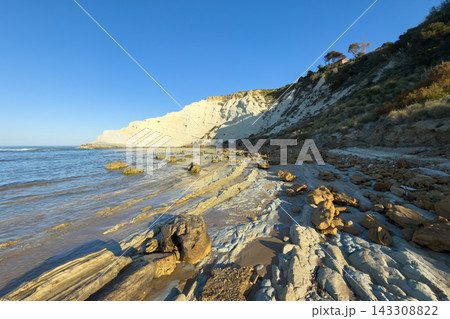 The white marl cliffs of Scala dei Turchi rise above the Mediterranean Sea in Sicily The white marl cliffs of Scala dei Turchi rise above the Mediterranean Sea in Sicily 143308822
