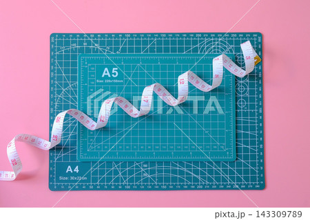 A green colored cutting mat tool with Measuring tape. A green colored cutting mat tool with Measuring tape. 143309789