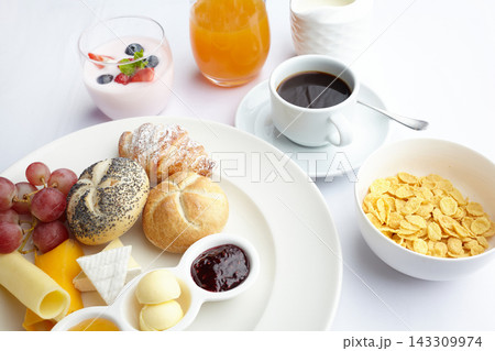 Breakfast spread with coffee, croissant, fruit, yogurt 143309974