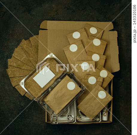 Set includes seed packets in brown paper bags, jute sprouting mats, plastic growing trays, and rolled instruction sheet. Microgreens growing kit with seed bags, sprouting mats 143310106
