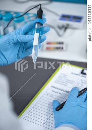 Laboratory Sample Testing with Gloved Scientist and Medical Equipment 143310315