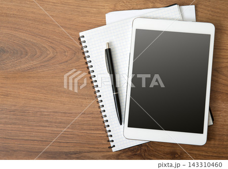 Tablet Mockup with Notebook and Pen on Wooden Desk 143310460