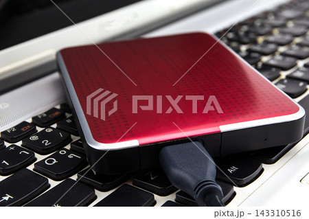 External Hard Drive Connected to Laptop Keyboard 143310516