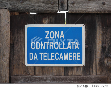 Video Surveillance Warning Sign on Rustic Wooden Fence 143310766
