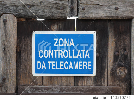 Surveillance Warning Sign on Rustic Wooden Gate Surveillance Warning Sign on Rustic Wooden Gate 143310776