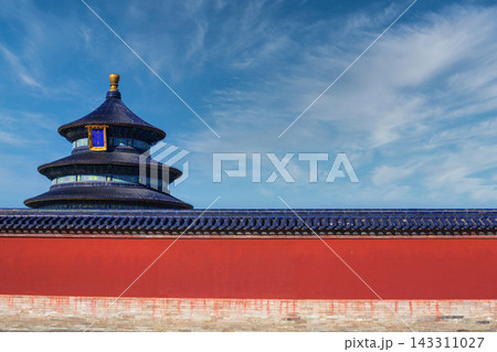 The Temple of Heaven in Beijing, China, with its iconic blue tiled roof and red wall under a clear blue sky. The Temple of Heaven in Beijing, China, with its iconic blue tiled roof and red wall under a clear blue sky. 143311027