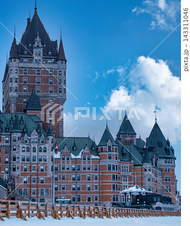 Fairmont Le Chateau Frontenac in Quebec City, Canada, under a blue sky with clouds Fairmont Le Chateau Frontenac in Quebec City, Canada, under a blue sky with clouds 143311046