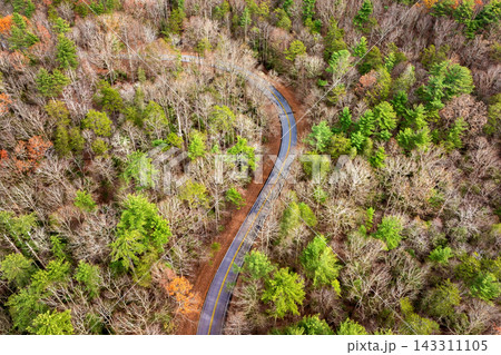 Car driving along mountain road surrounded by colorful autumn trees in Tennessee. Scenic road trip through the Appalachians in fall season 143311105