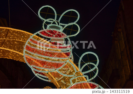 Giant Christmas baubles with red and white LED lights suspended above the streets of downtown Vigo during the famous Christmas lights display. 143311519
