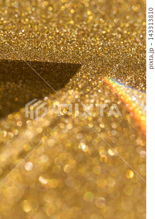Vertical Golden Glitter Surface With Dark Geometric Shadow And Narrow Rainbow Reflection, Showing 143313810