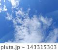 Blue sky with white clouds and subtle lens flare. Natural sunny background 143315303