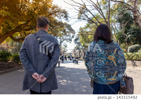 紅葉の並木道を歩くカップルの後ろ姿 紅葉の並木道を歩くカップルの後ろ姿 143315492