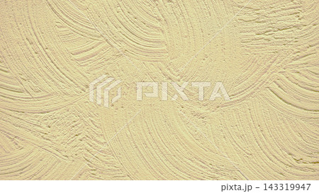Pale yellow ocher paint brush smears on wall 143319947