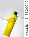 Floating Yellow Cosmetic Bottle in Water Splash 143320049