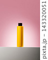 Yellow cosmetic bottle on pink background 143320051