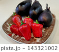 皿に盛られたなすと赤ピーマン 143321002