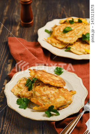 Home cooking vegetable fritters served on plates with garnishes 143321878