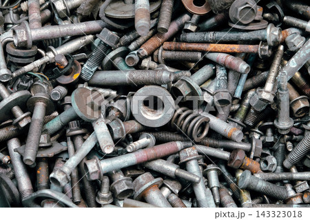 Rusty metal bolts and screws creating industrial background 143323018