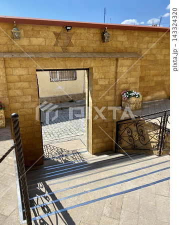 Stone staircase and decorative Jewish symbols appear in a historic courtyard. Stone staircase and decorative Jewish symbols appear in a historic courtyard. 143324320