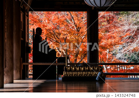 Buddha statue in Hase-dera temple with red autumn leaf, Nara Buddha statue in Hase-dera temple with red autumn leaf, Nara 143324748