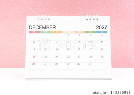 December 2027, Desk calendar with pink flower pattern embossed as background. December 2027, Desk calendar with pink flower pattern embossed as background. 143326951
