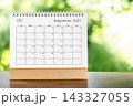 September 2027 Calendar desk for organizer to plan and reminder on wooden table. 143327055