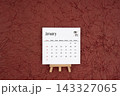 January 2027 calendar on red crumpled paper background. Directly above. 143327065
