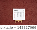 February 2027 calendar on red crumpled paper background. Directly above. 143327066