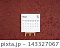 March 2027 calendar on red crumpled paper background. Directly above. 143327067