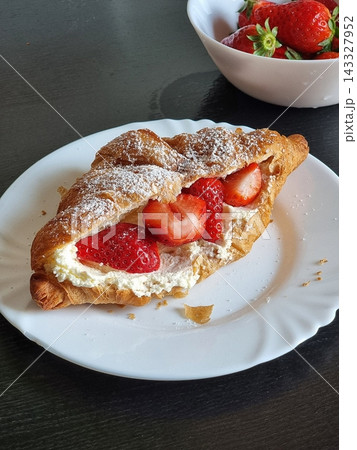 Buttery croissant filled with fresh fruits and whipped cream, offering a perfect mix of crisp, flaky layers and sweet, refreshing flavors in every delightful, elegant bite. Buttery croissant filled with fresh fruits and whipped cream, offering a perfect mix of crisp, flaky layers and sweet, refreshing flavors in every delightful, elegant bite. 143327952