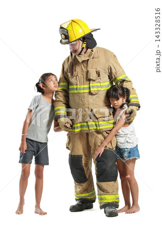 Asian male firefighter carrying child and leading another to safety Asian male firefighter carrying child and leading another to safety 143328516
